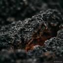 Volcanic basalt texture with amber ember glow